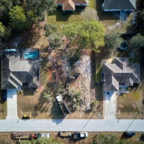 Aerial view of a cleared lot with the ground graded flat and ready to build on